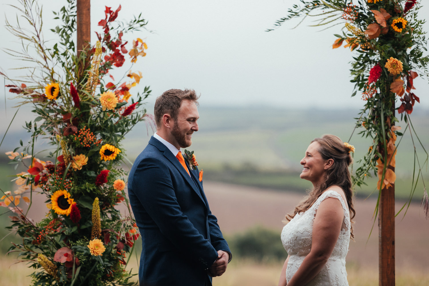 bride and groom, wedding ceremony, wedding arch, sunflowers, wedding flowers, wedding arch, Rock Cornwall Wedding Photography, wedding photographer cornwall